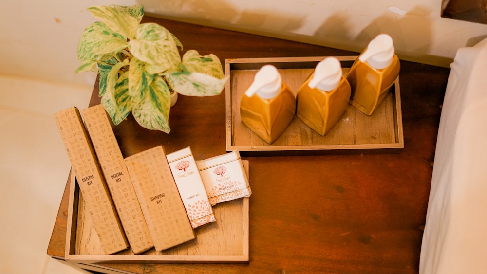 a wooden table with a box of cigarettes and a leafy plant