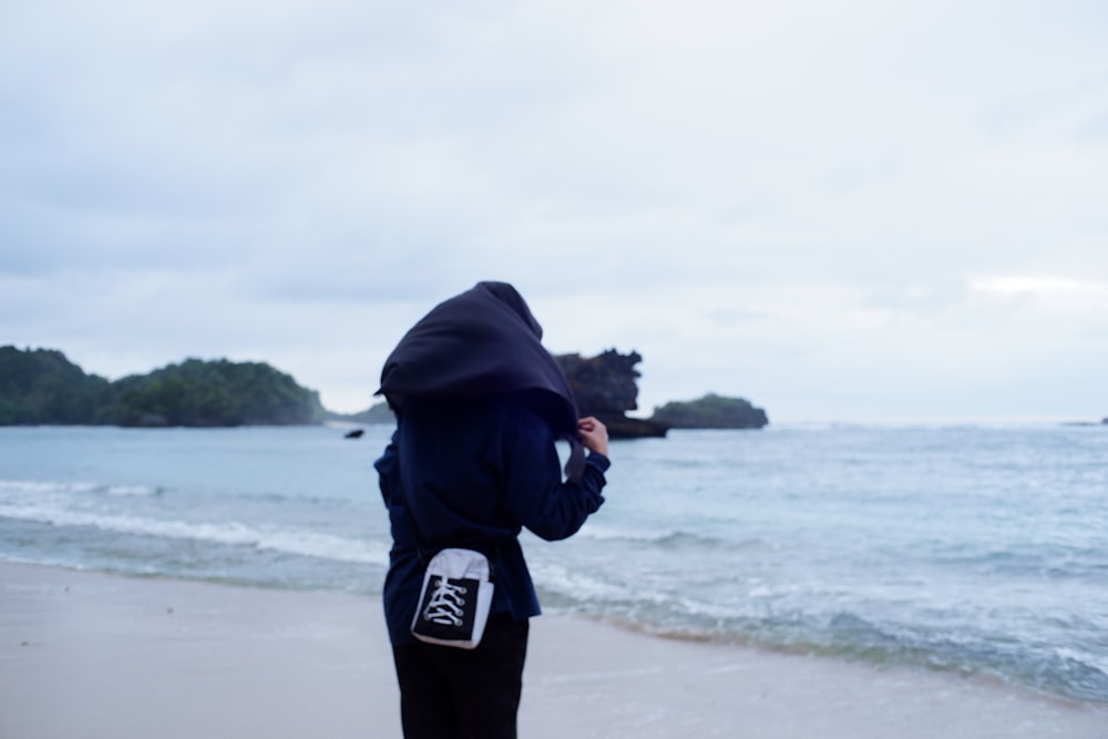 a person holding a can on a beach