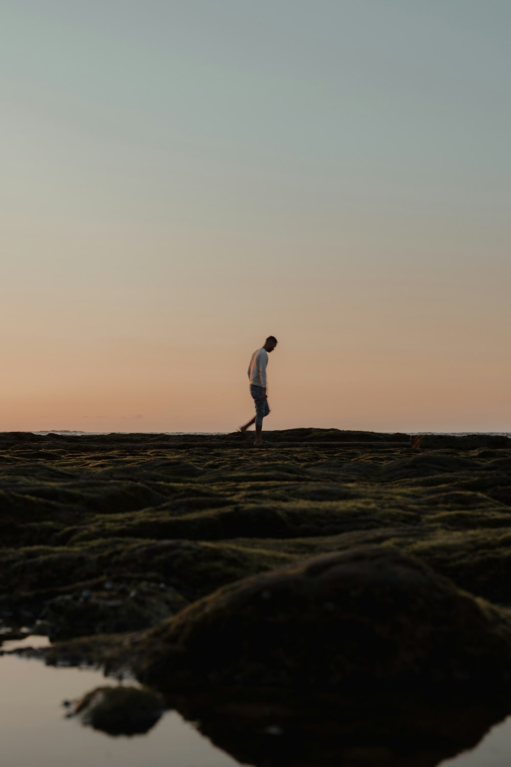 a man walking on a beach