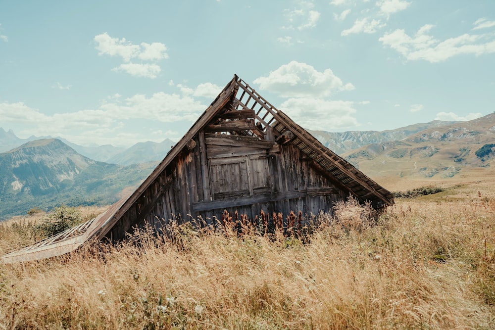 a wooden building in a field