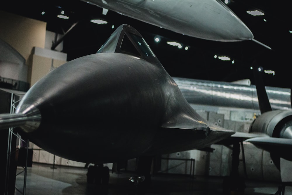 a black airplane in a hangar