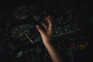 a hand reaching out to a large machine