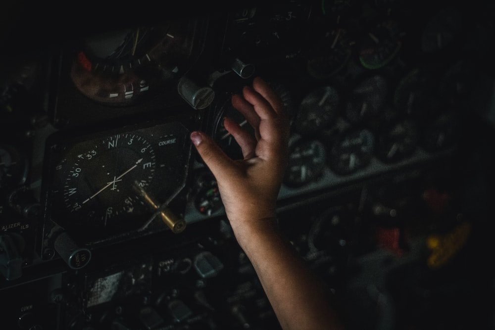 a hand reaching out to a large machine