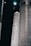A large rocket labeled 'US Air Force' is positioned in a dark, industrial setting. The rocket is primarily white with bold black lettering, and there are other large structural components visible in the background.