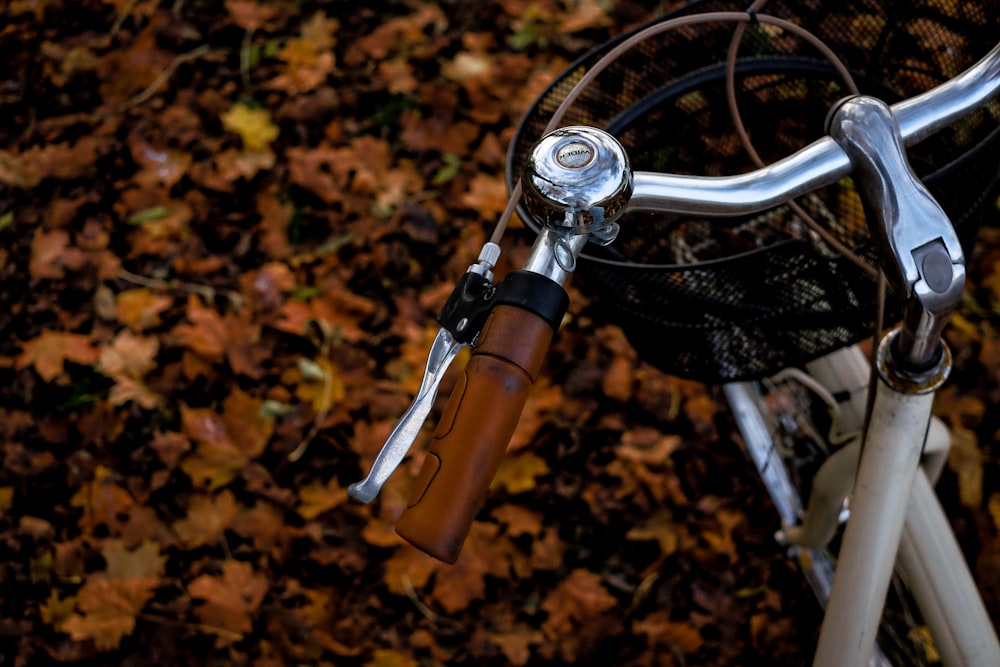 a bicycle parked in a pile of leaves