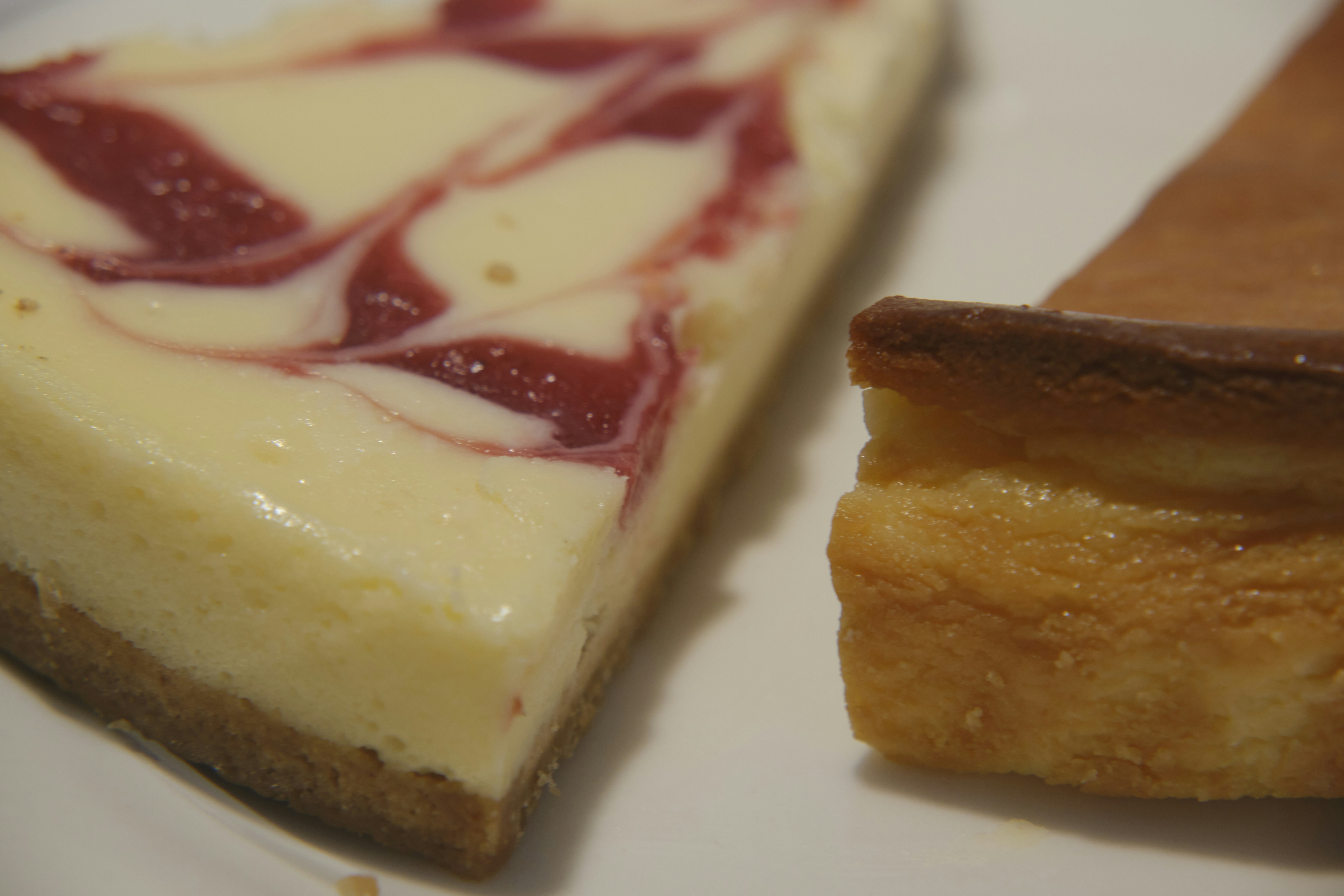 a slice of cake with jam, different fruit cheesecakes macro shot on plate