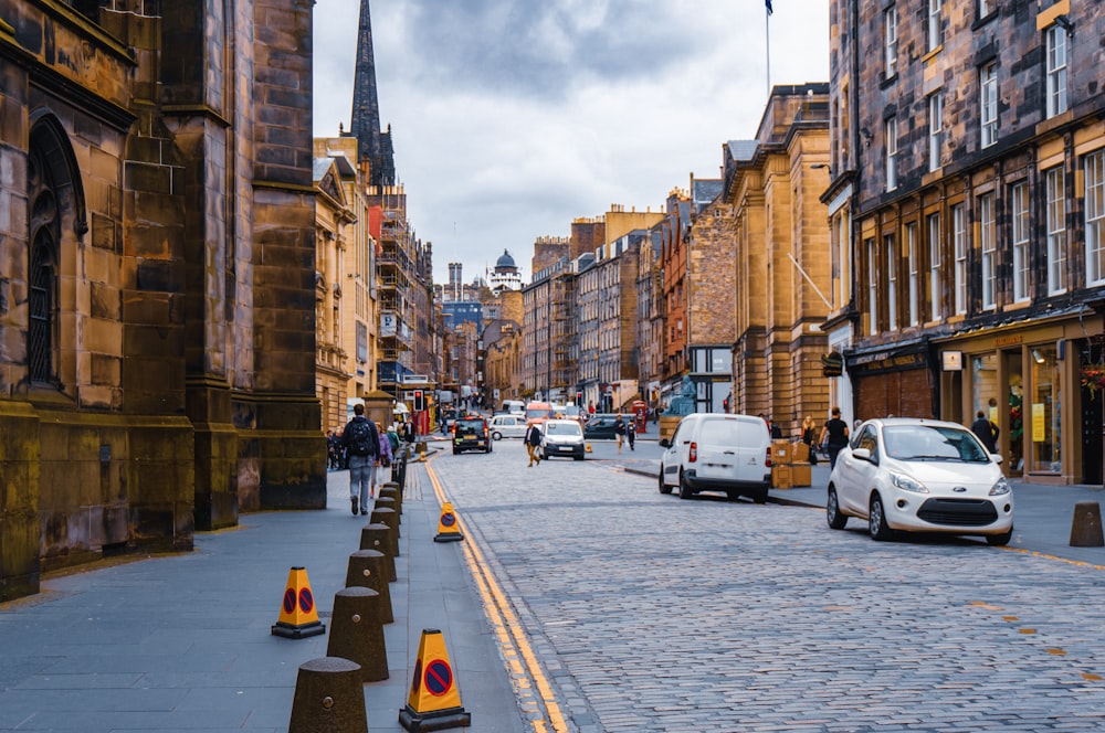 a street with cars and people on it and buildings on the side