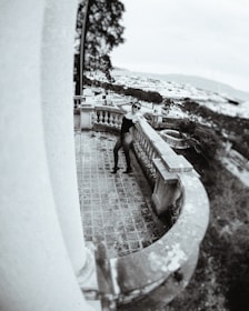 An artistic photo of a young, stylish model call girl posing confidently against a cityscape backdrop.
