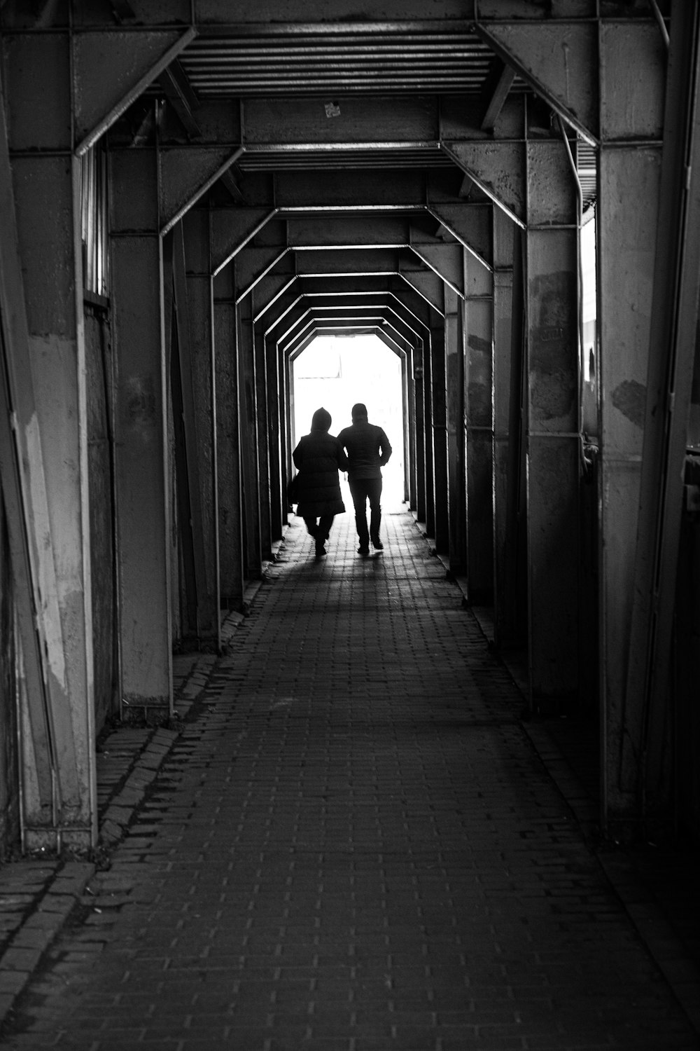 a man and woman walking down a hallway