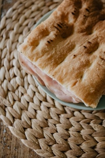 Close-up of a gourmet kebab sandwich bursting with fresh Spanish ingredients and vibrant colors.