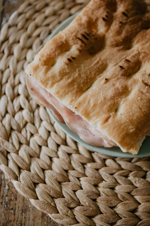 Close-up of a delicious kabab sandwich with fresh ingredients on a modern wooden table