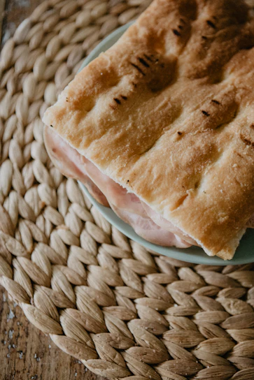 A vibrant close-up of a freshly made Thai sandwich with colorful ingredients on rustic bread.