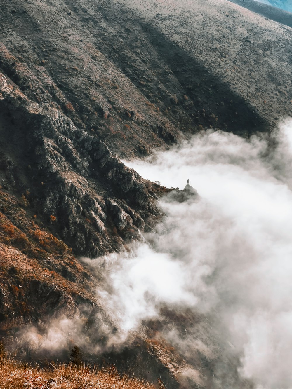 a mountain with clouds