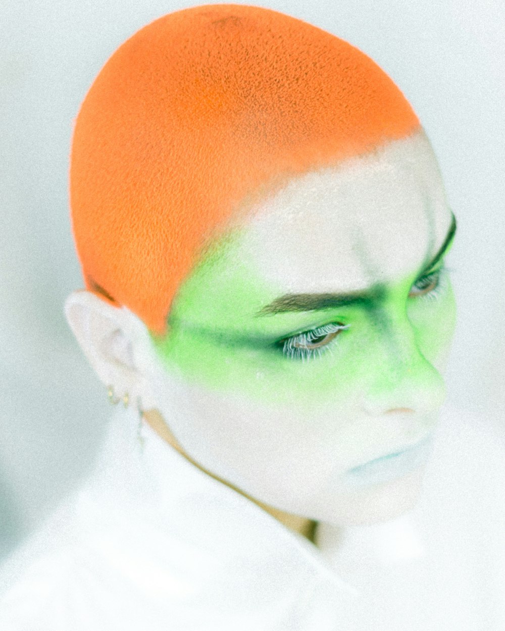 a person with a green face and a white background