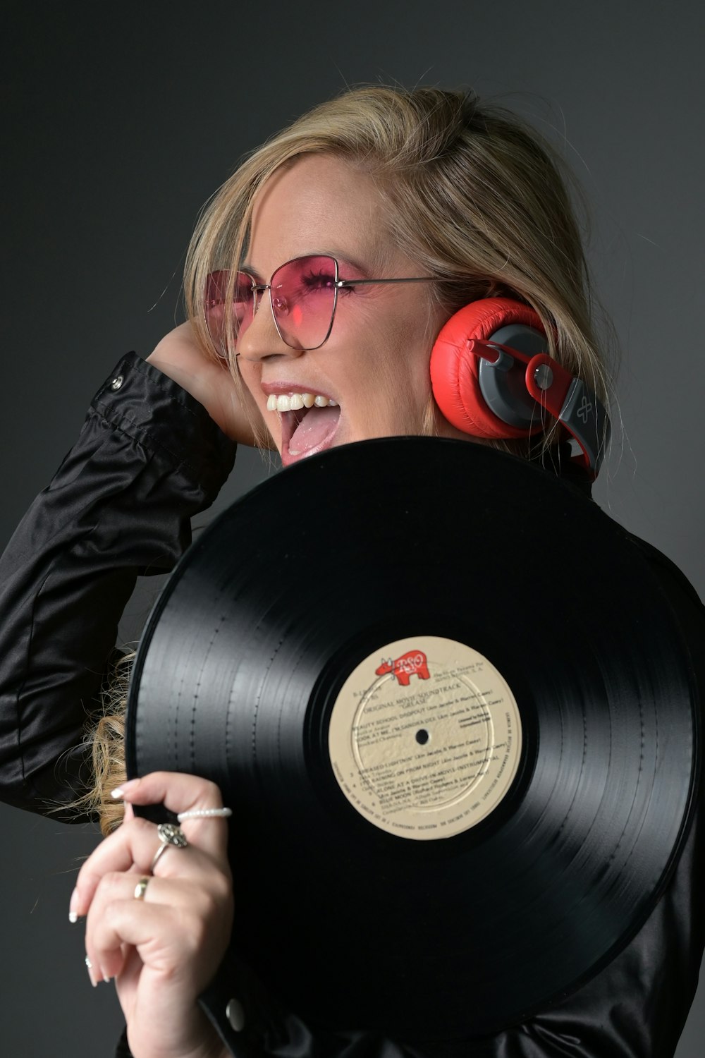 a person holding a black speaker