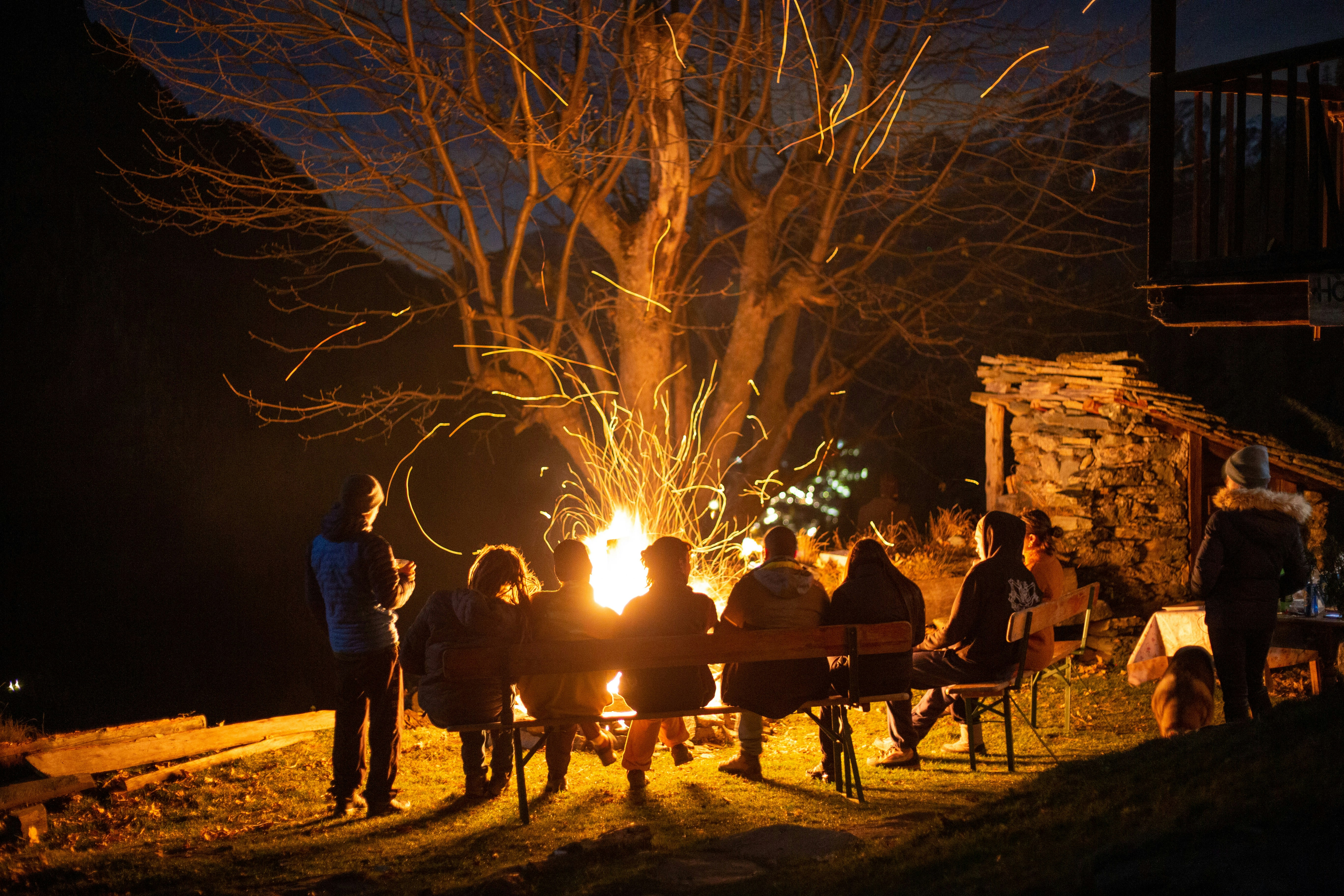 Moonlit gathering around fire
