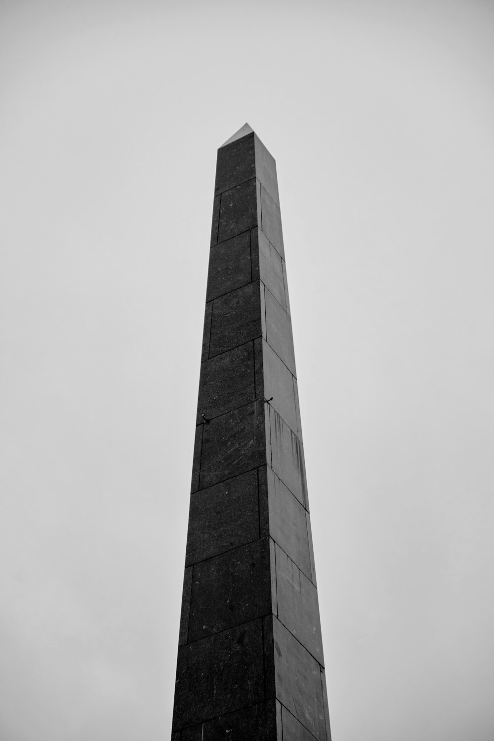 a tall building with a cloudy sky