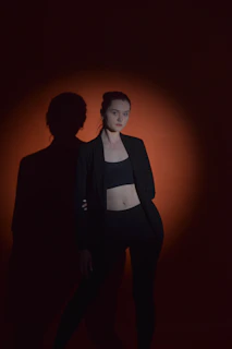 High-contrast shot of a minimalist black t-shirt illuminated by a single spotlight