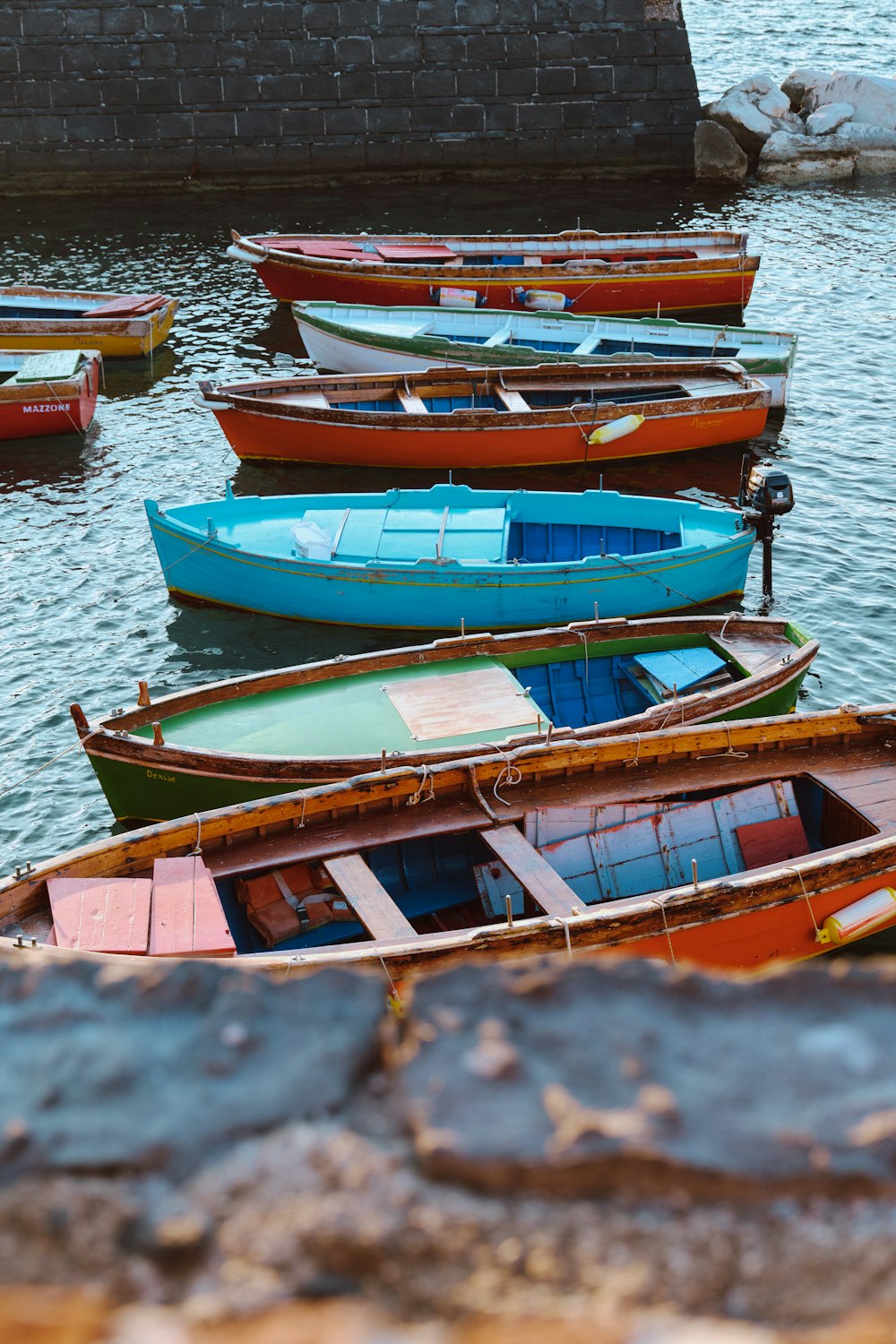 a group of boats sit on the water
