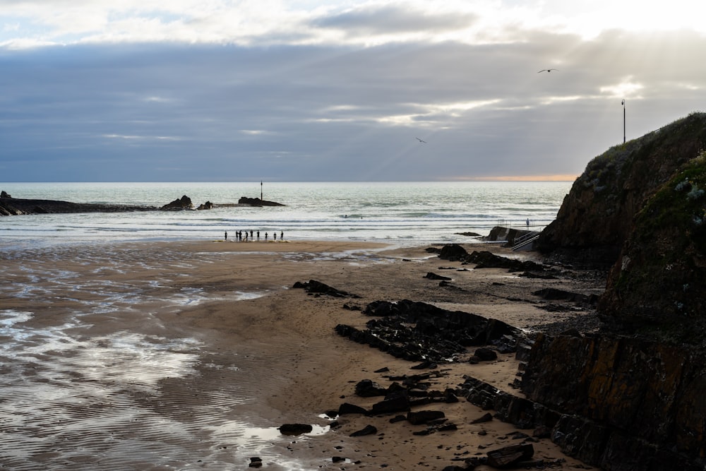 a beach with rocks and a boat