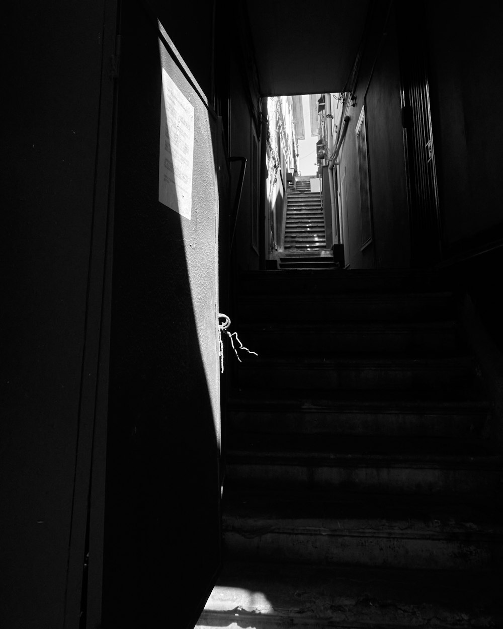 a dark staircase with a window