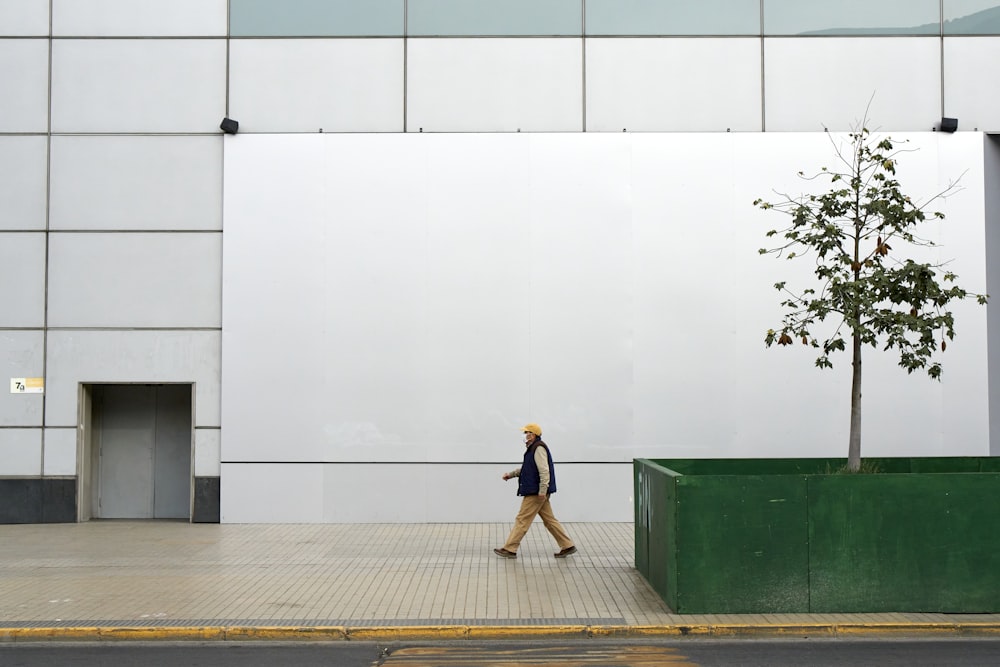 a man walking on a sidewalk