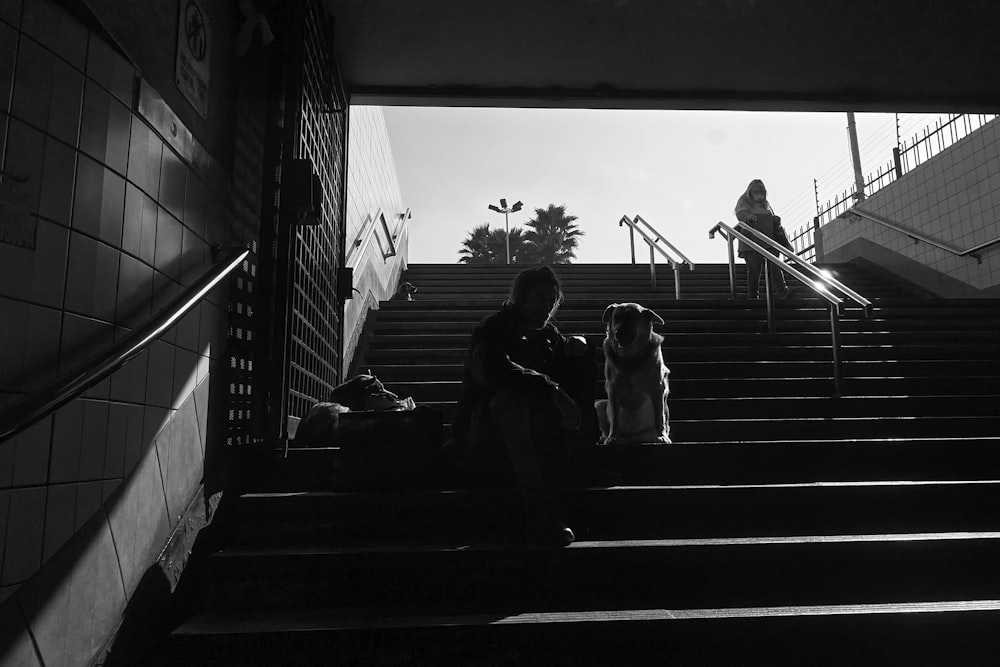 a group of people sitting on the steps of a building