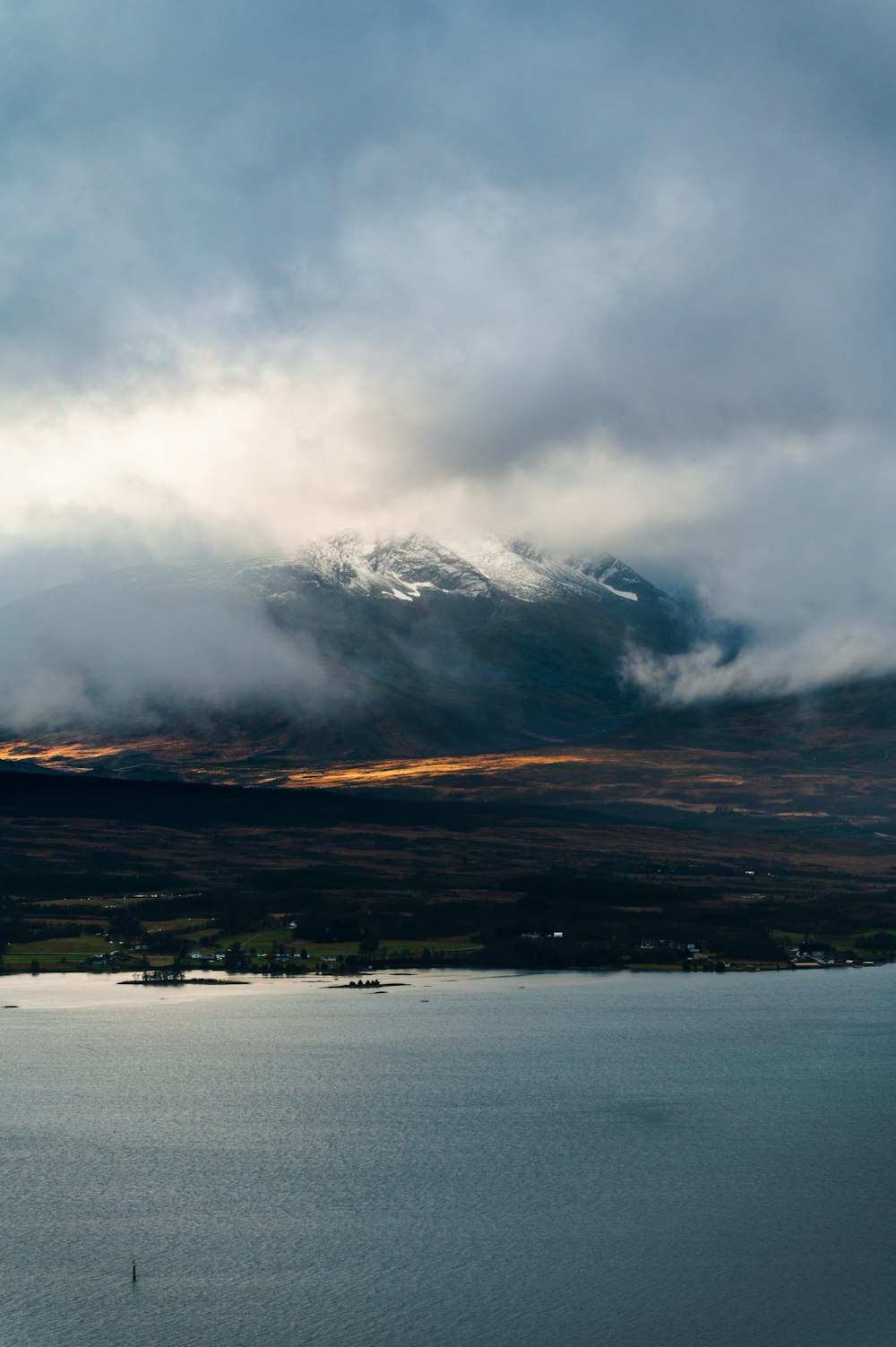 a body of water with a mountain in the background