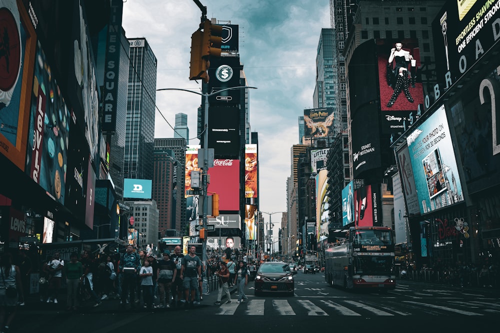 a busy city street with Times Square in the background