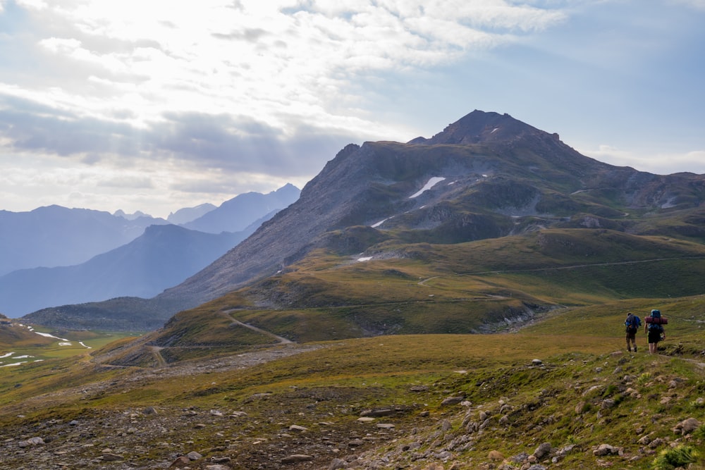 a group of people hiking in the mountains