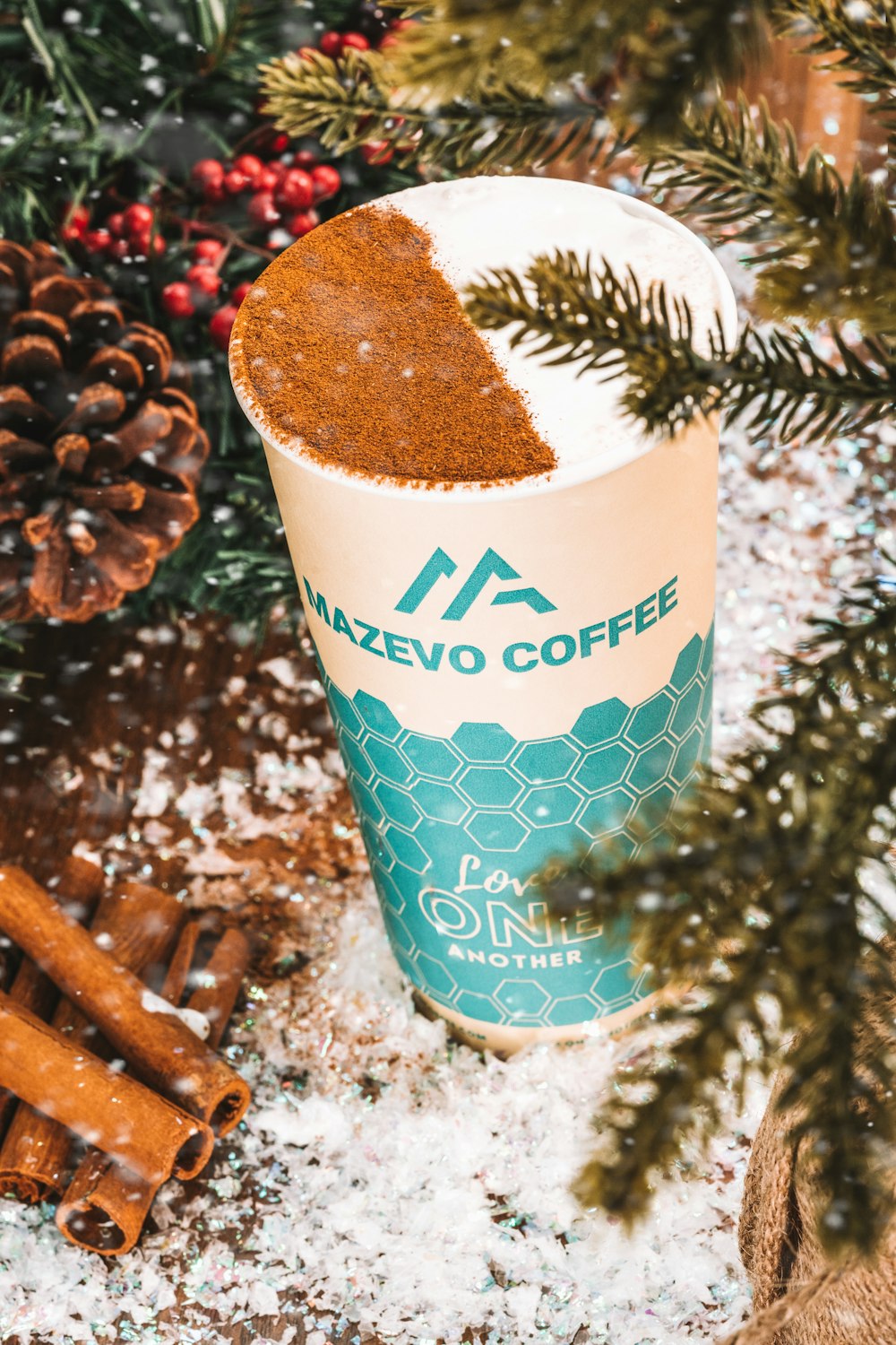 a cup of coffee in front of a christmas tree