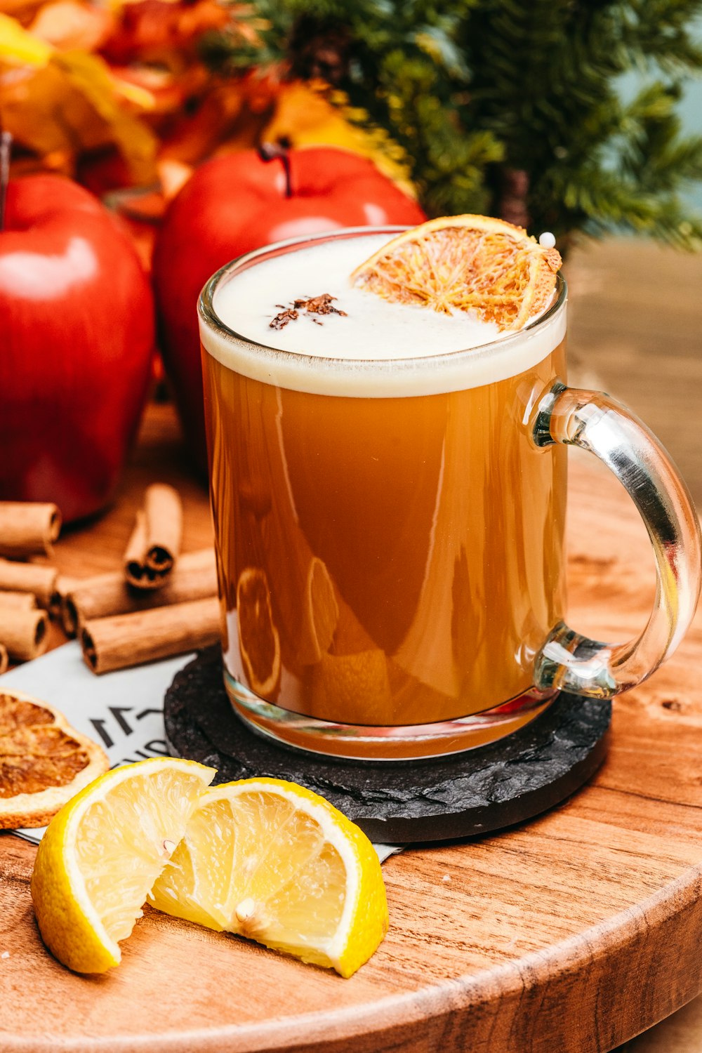 a glass of tea with lemons and a slice of lemon