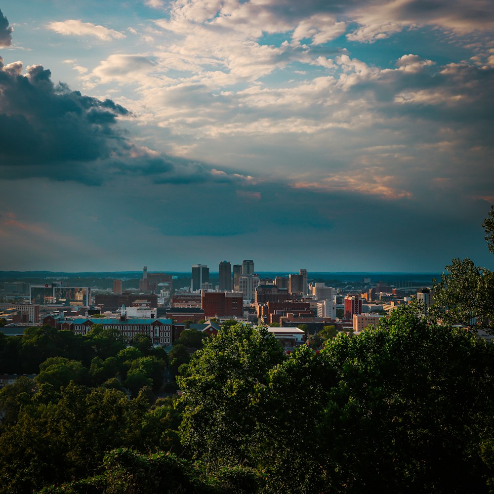 a city with trees and clouds