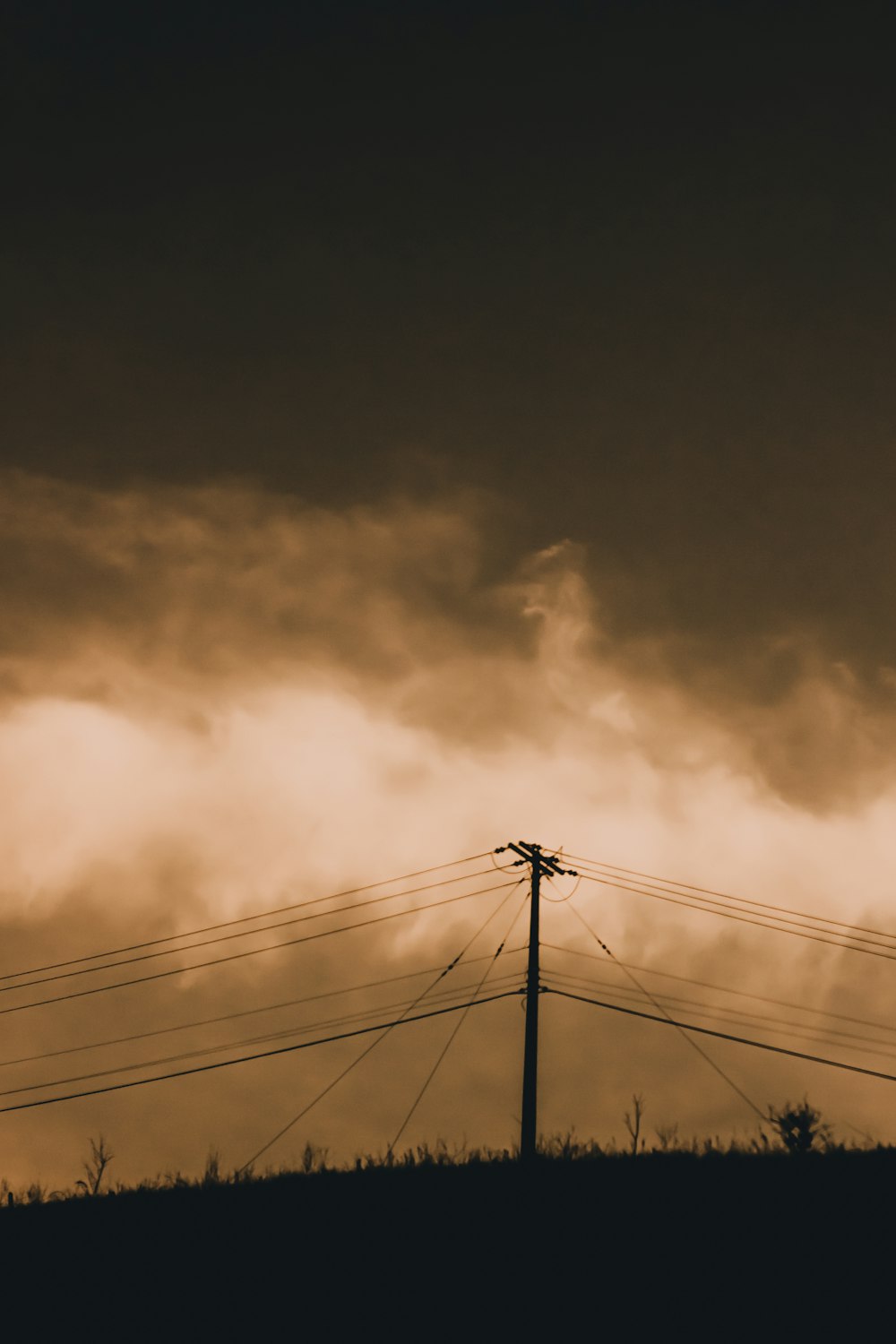 a sunset over power lines