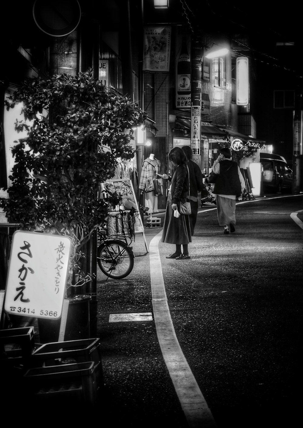 a couple of people walk down a sidewalk