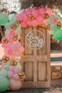 a wooden door with balloons around it