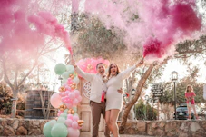 a man and woman holding balloons