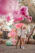 A joyful family surrounded by pastel-colored balloons and twinkling event lights at an outdoor celebration.