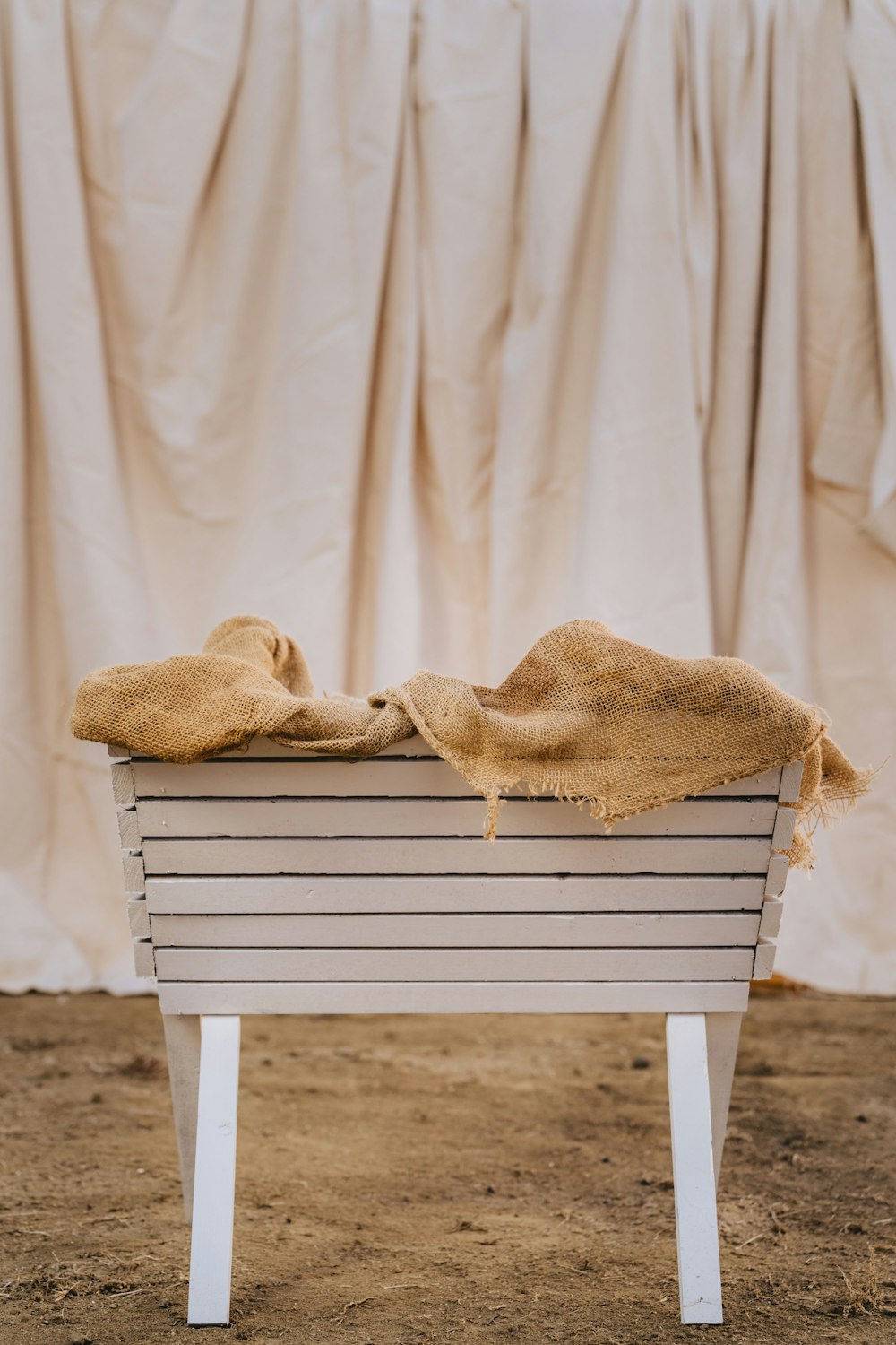 a wicker chair with a blanket on it