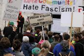 Activists holding signs advocating for fair wages during a peaceful rally.