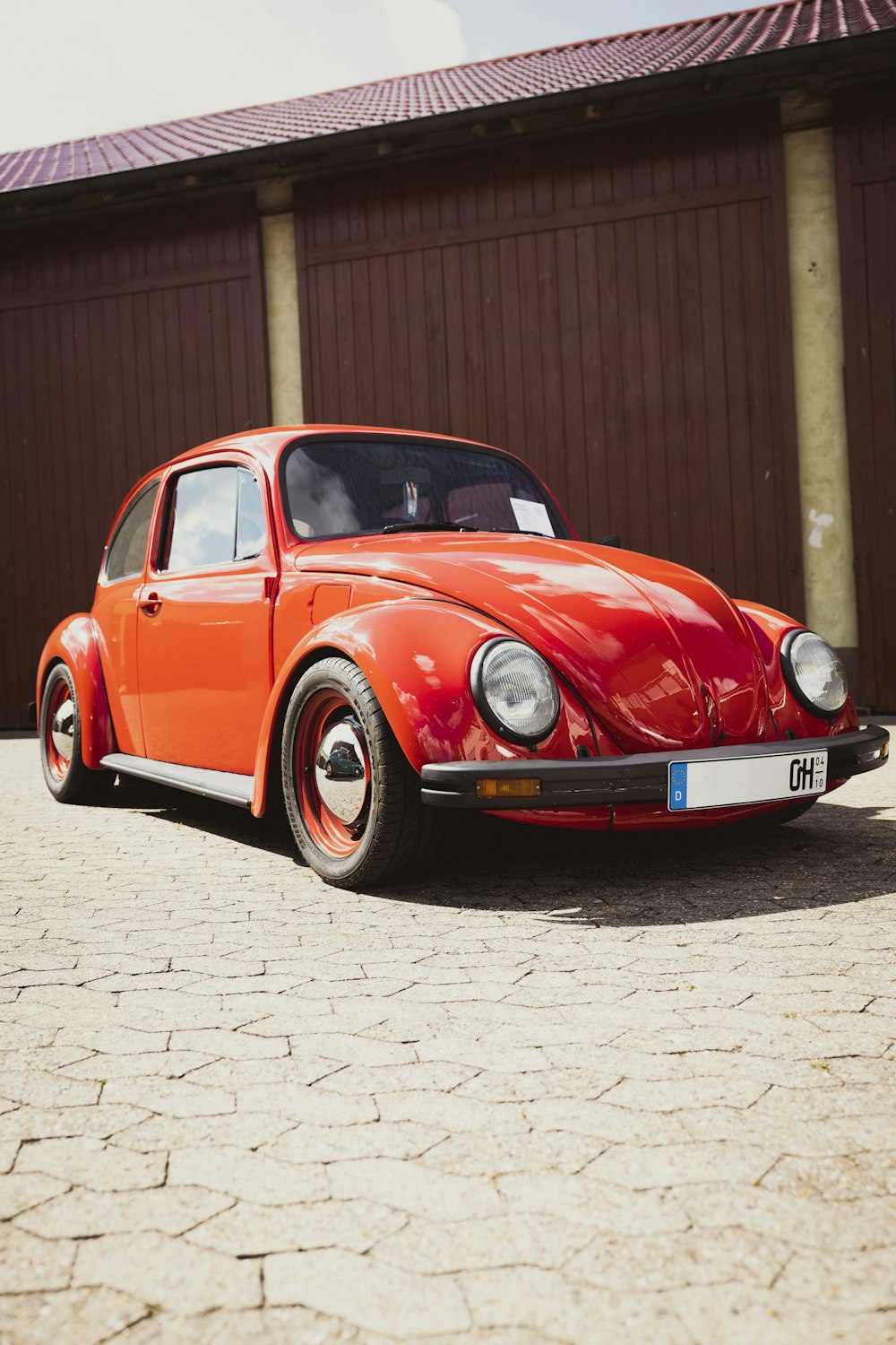 an orange car parked in front of a building