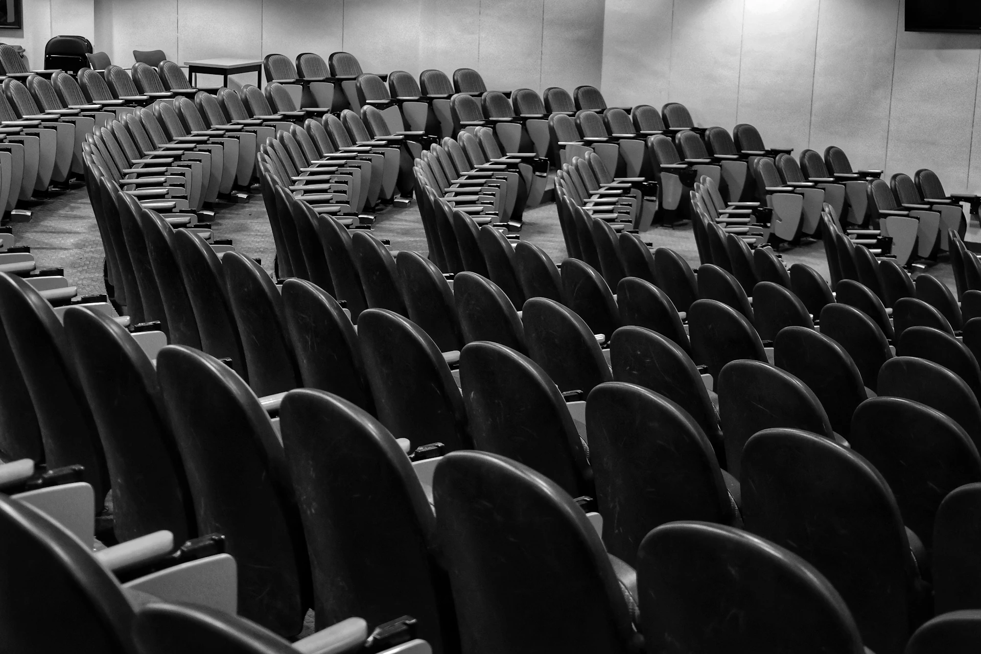 Empty hall with rows of empty chairs