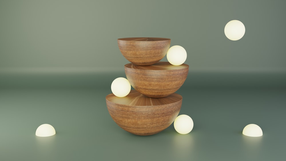 a group of wooden bowls with white balls in the background