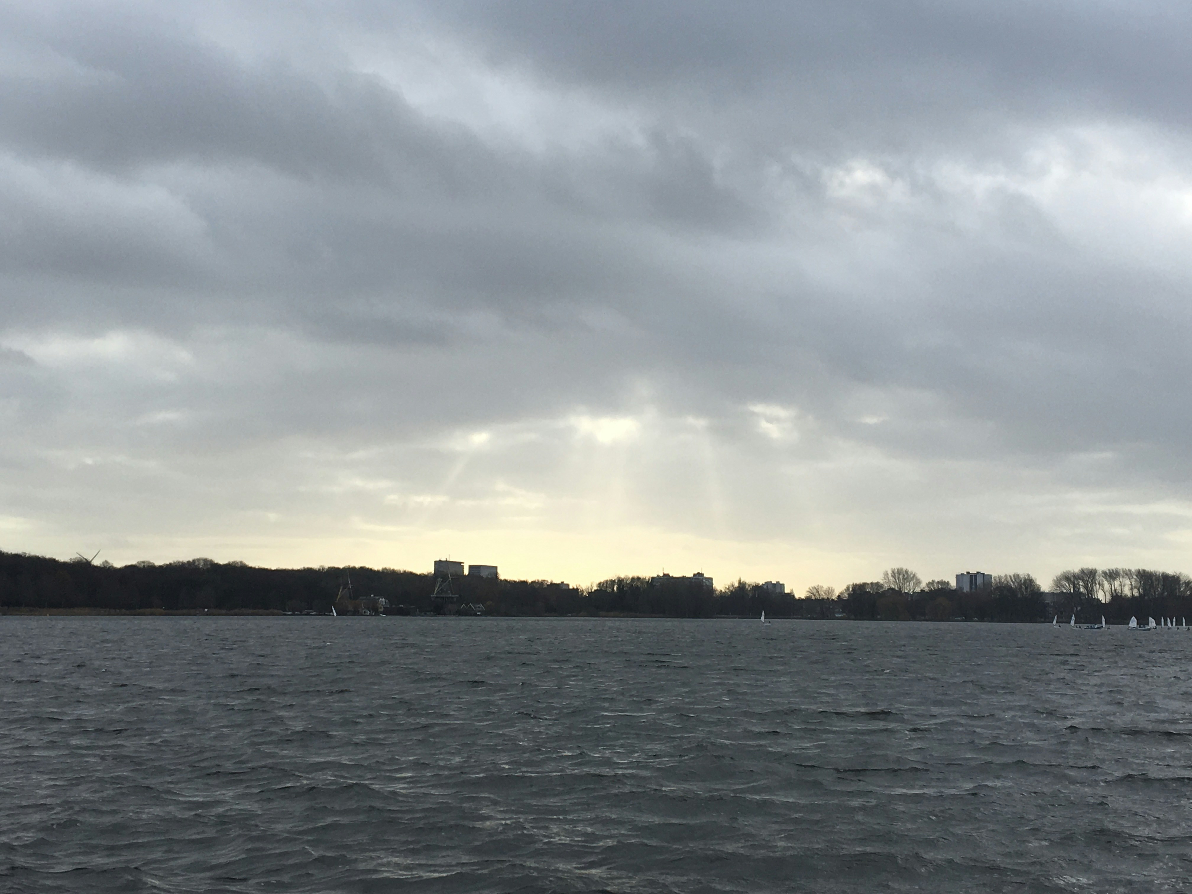 a body of water with a city in the distance