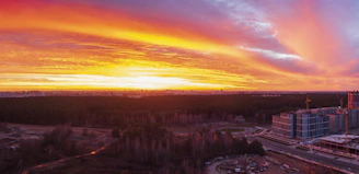 A vibrant behind-the-scenes shot of a film crew capturing a dynamic cityscape at sunset.