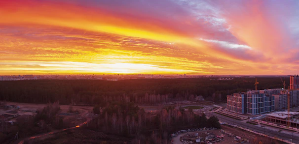 A vibrant behind-the-scenes shot of a film crew capturing a dynamic cityscape at sunset.