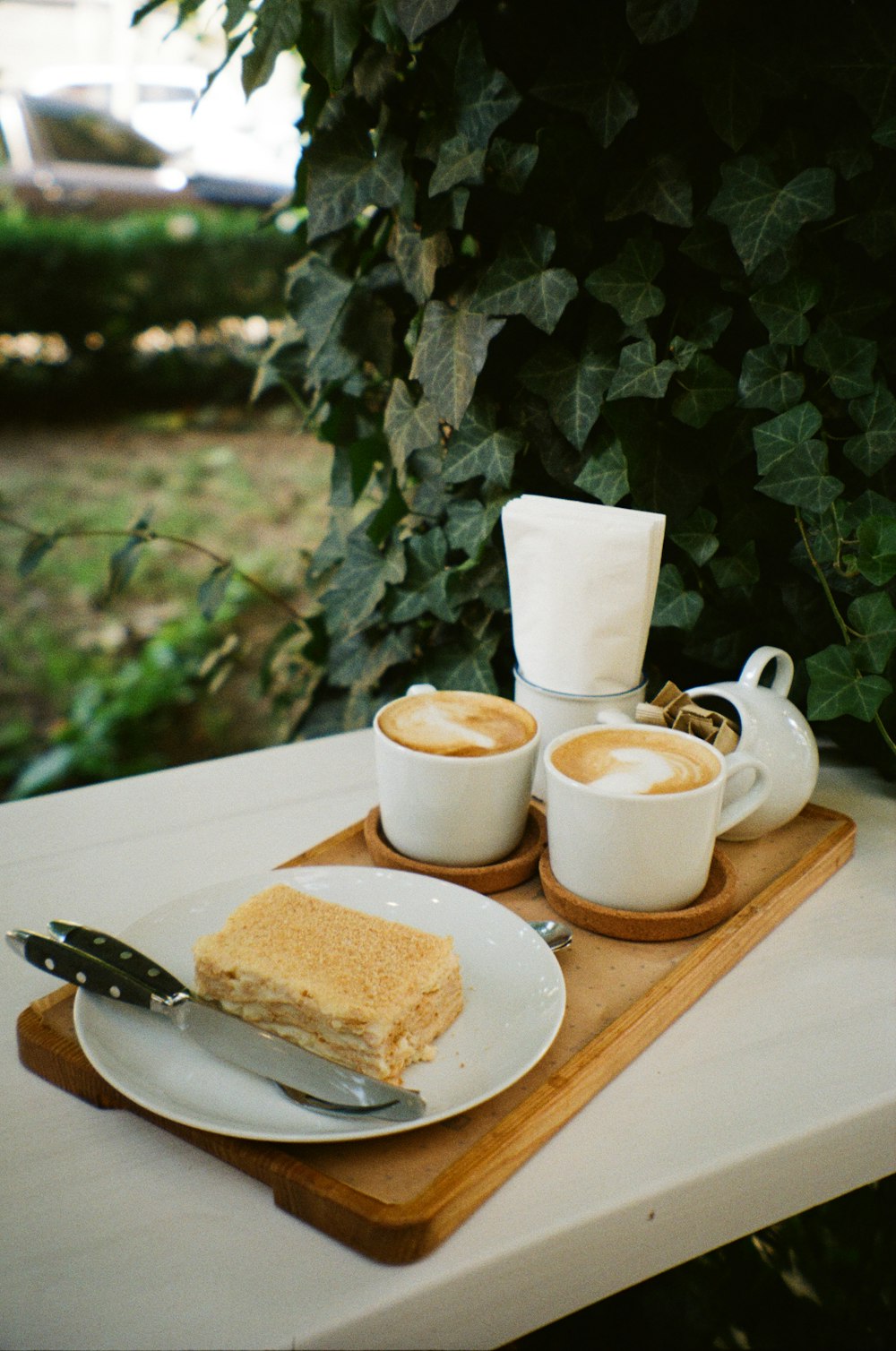 a plate of food and cups of coffee on a table