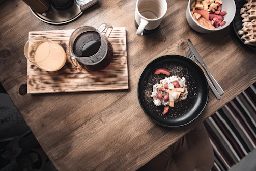 a table with plates of food and a drink on it
