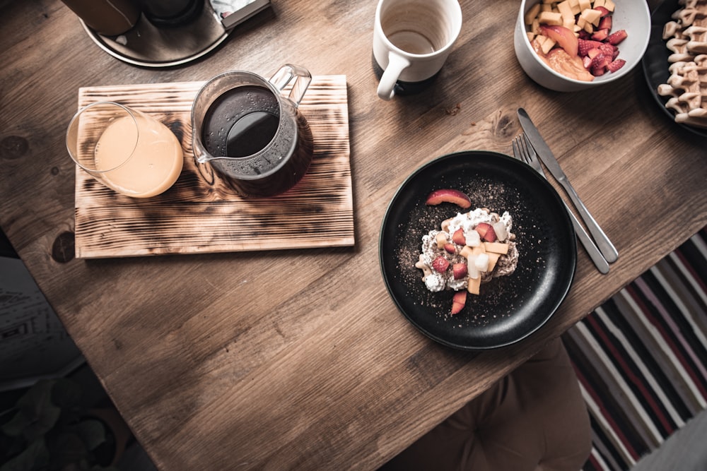 a table with plates of food and a drink on it