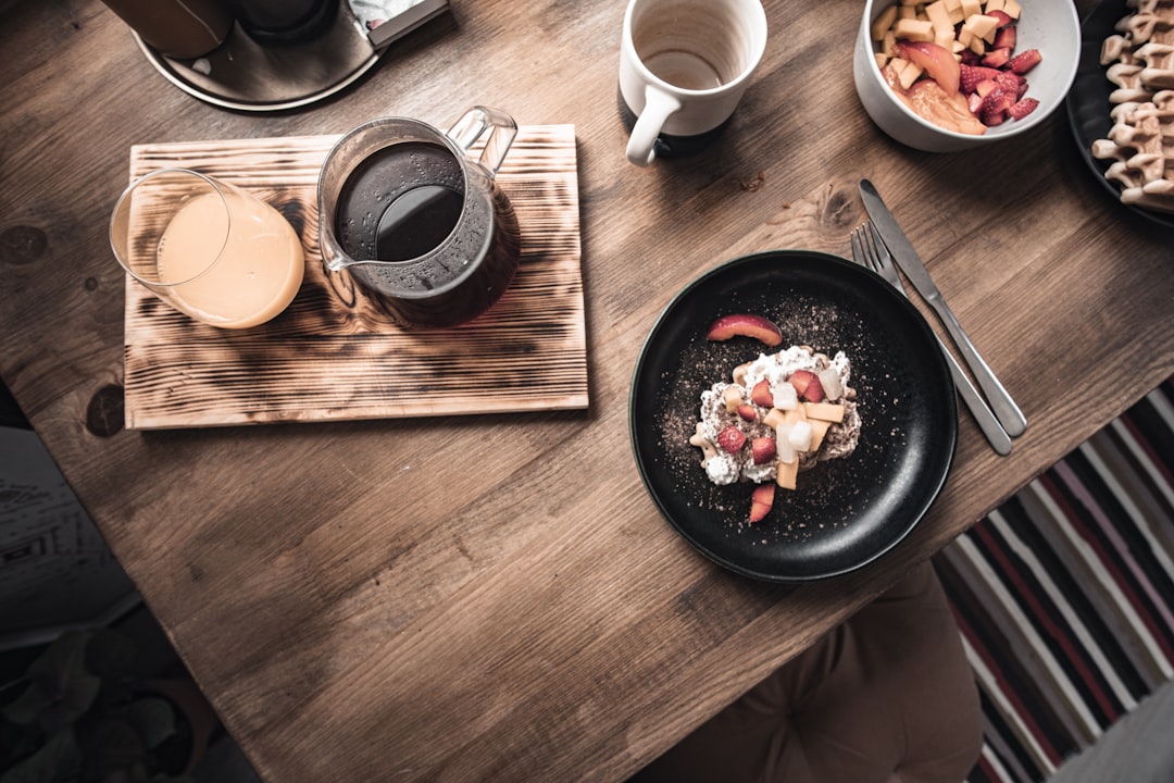 a table with plates of food and a drink on it,